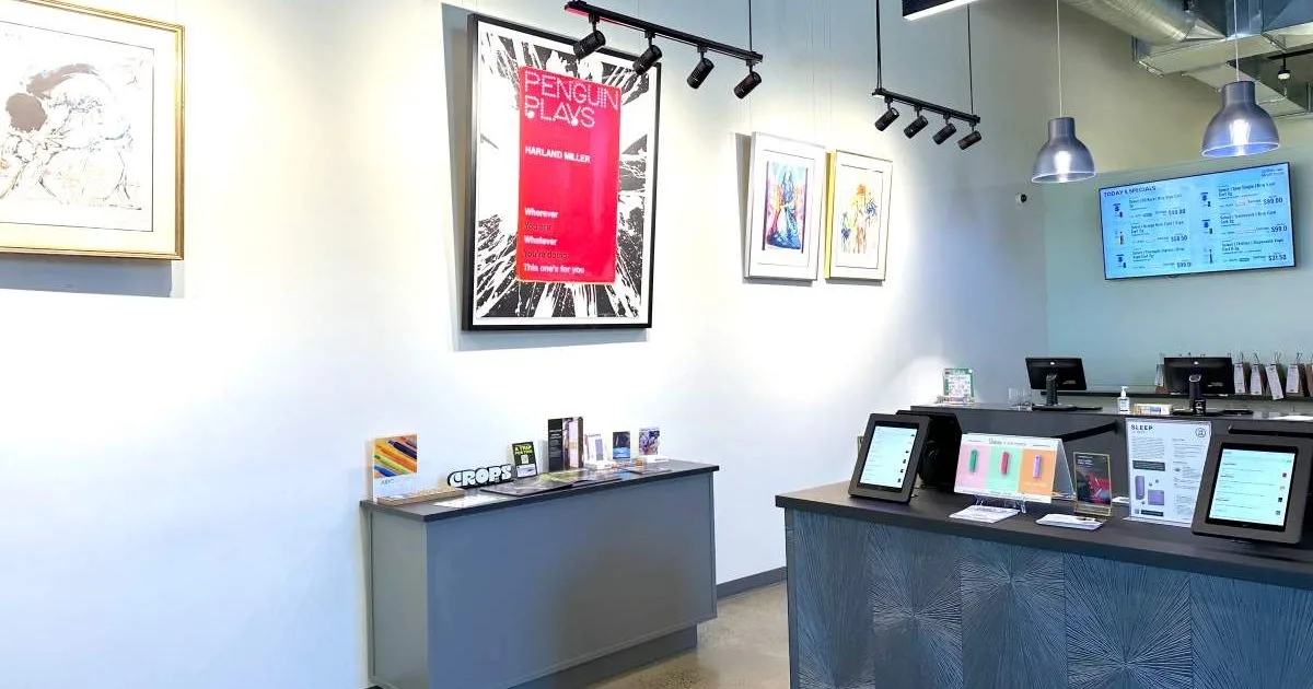 Modern cannabis dispensary interior with product displays and counter