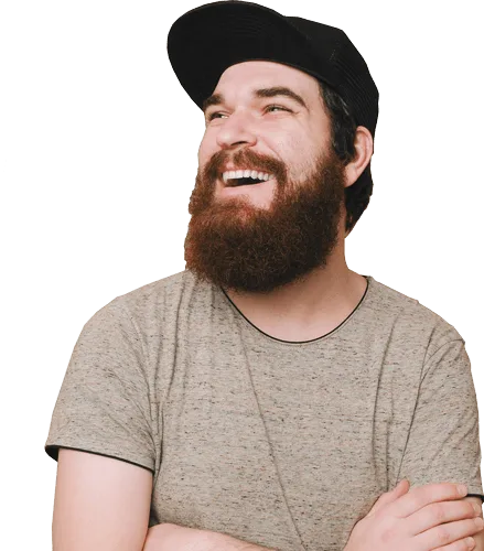 Bearded man wearing cap smiling and looking sideways