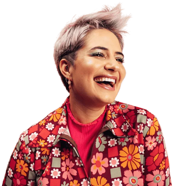 Woman with short hair smiling wearing colorful floral jacket